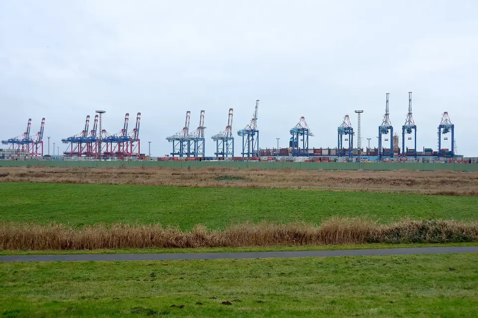 Container port freight operations with cranes and cargo handling.