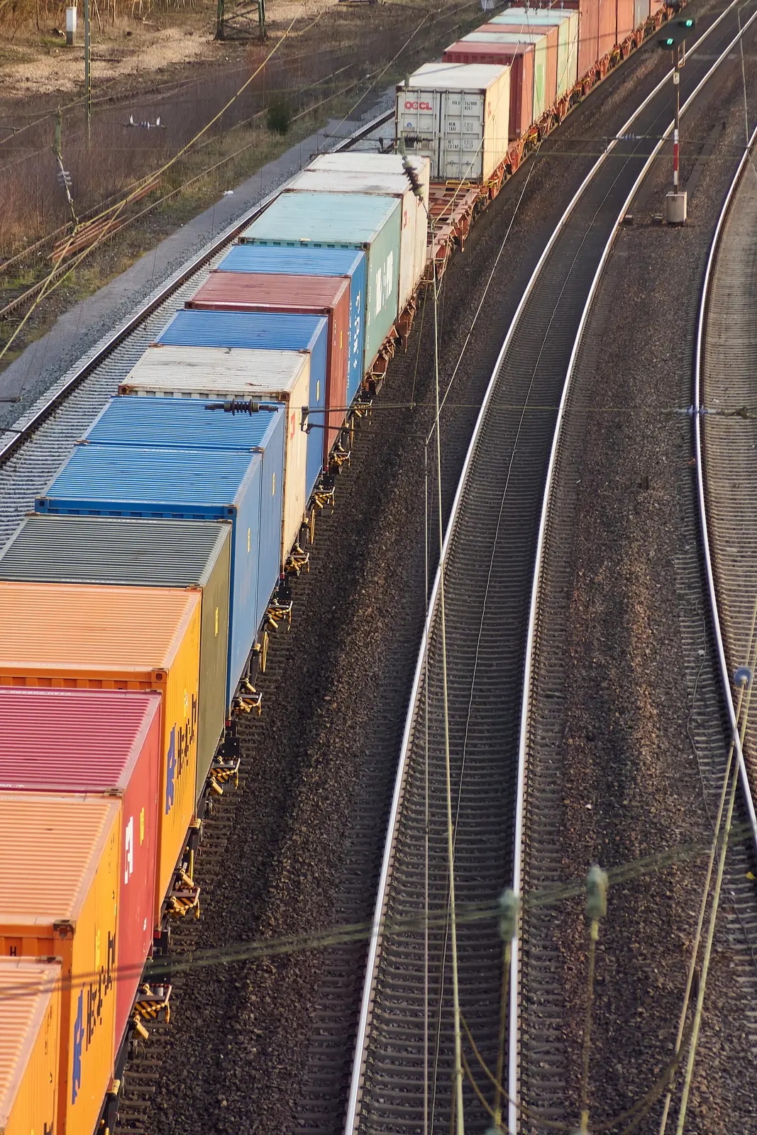 Container train carrying international freight through a European rail corridor.